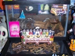 A stack of terrariums, a "Day of the Dead" last supper, and Halloween Smurfs.
